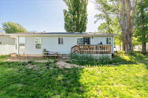 Rear view of house with a wooden deck