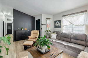 Living room with light wood-style flooring
