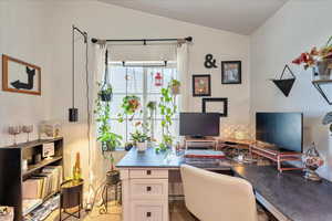 Office area featuring lofted ceiling