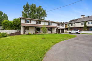 Traditional-style home with asphalt driveway and brick siding