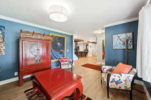 Interior space featuring wood finished floors and crown molding