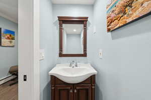 Bathroom with vanity and wood finished floors