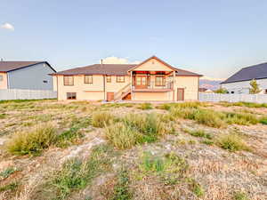 Back of property featuring stairway and a mountain view