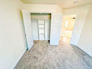 Unfurnished bedroom featuring light colored carpet and a closet