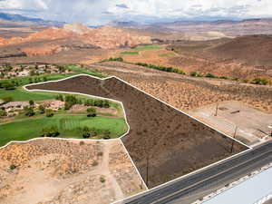 Aerial view of sparsely populated area with property boundaries highlighted and a mountain backdrop