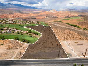 Aerial view of property's location featuring property parcel outlined and a mountainous background