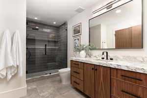 Full bathroom featuring vanity, a stall shower, and recessed lighting
