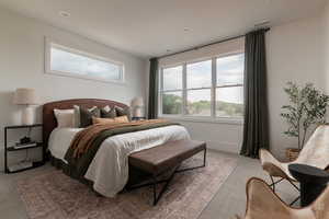 Bedroom with light colored carpet and recessed lighting