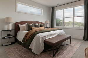Bedroom featuring light carpet and baseboards