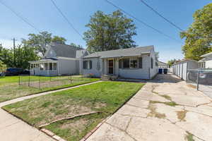 View of front of home with roof with shingles and an outdoor structure