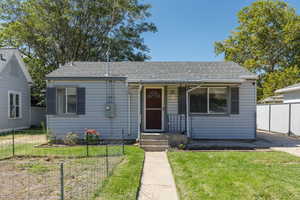 Bungalow-style house featuring roof with shingles