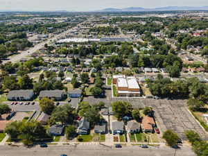 Aerial overview of property's location with nearby suburban area and a mountainous background