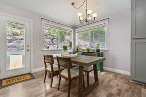 Dining room featuring light wood-style floors, a chandelier, and radiator heating unit