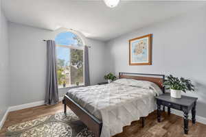 Bedroom featuring baseboards and wood finished floors