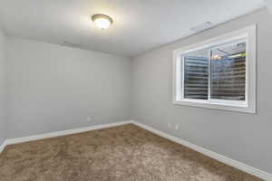 Spare room with baseboards and carpet flooring