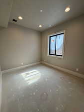 Unfurnished room with recessed lighting and a textured ceiling