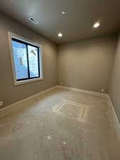 Unfurnished room featuring baseboards and a textured ceiling