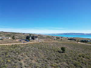 Aerial view of property and surrounding area featuring a water and mountain view