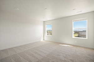 Unfurnished room featuring carpet floors and a textured ceiling