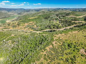 Aerial view of property's location featuring a mountainous background
