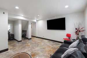 Living room featuring recessed lighting and concrete floors