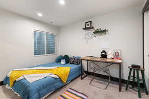 Carpeted bedroom with baseboards and recessed lighting