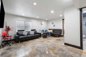 Living room featuring concrete floors and recessed lighting