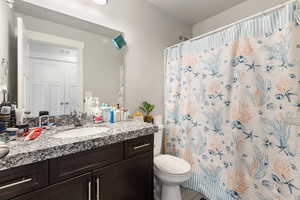 Bathroom featuring vanity and toilet