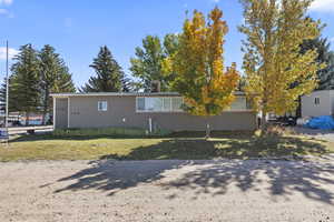 View of front of home featuring a chimney and a front lawn