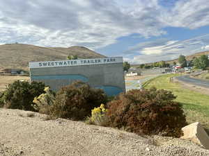 Community sign with a mountain view
