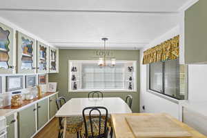 Dining room with a chandelier, wood finished floors, and plenty of natural light