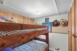 Bedroom with wood walls