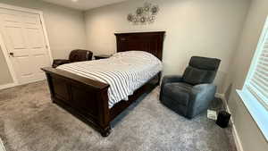 Carpeted bedroom featuring baseboards