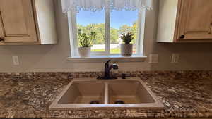 Kitchen view of dark stone countertops and light brown cabinets