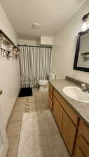 Full bathroom featuring vanity and light tile patterned flooring
