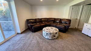 Living area with dark carpet and baseboards
