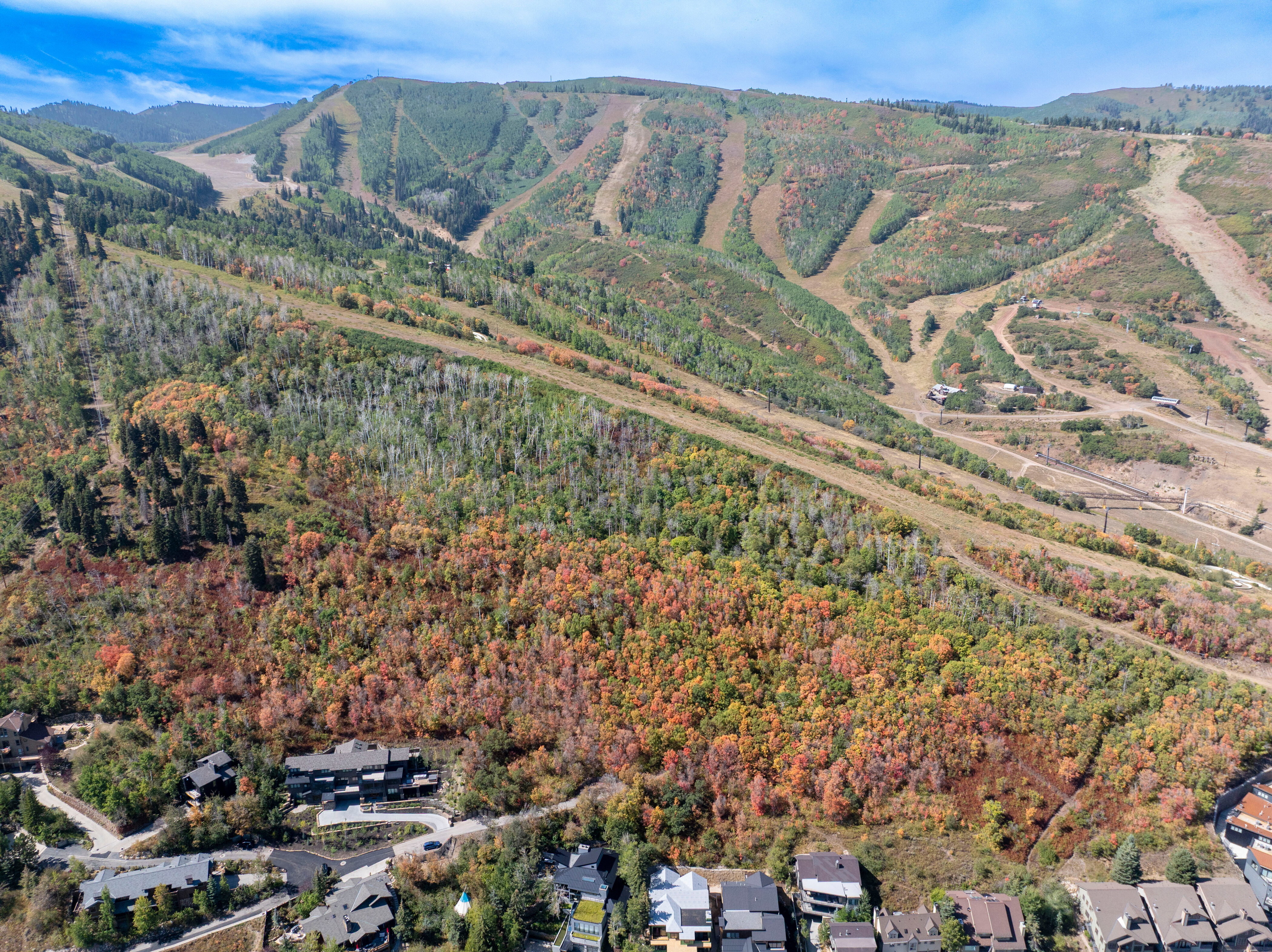 Aerial view of property and surrounding area with a mountainous background