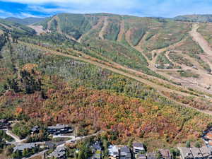 Aerial view of property and surrounding area with a mountainous background