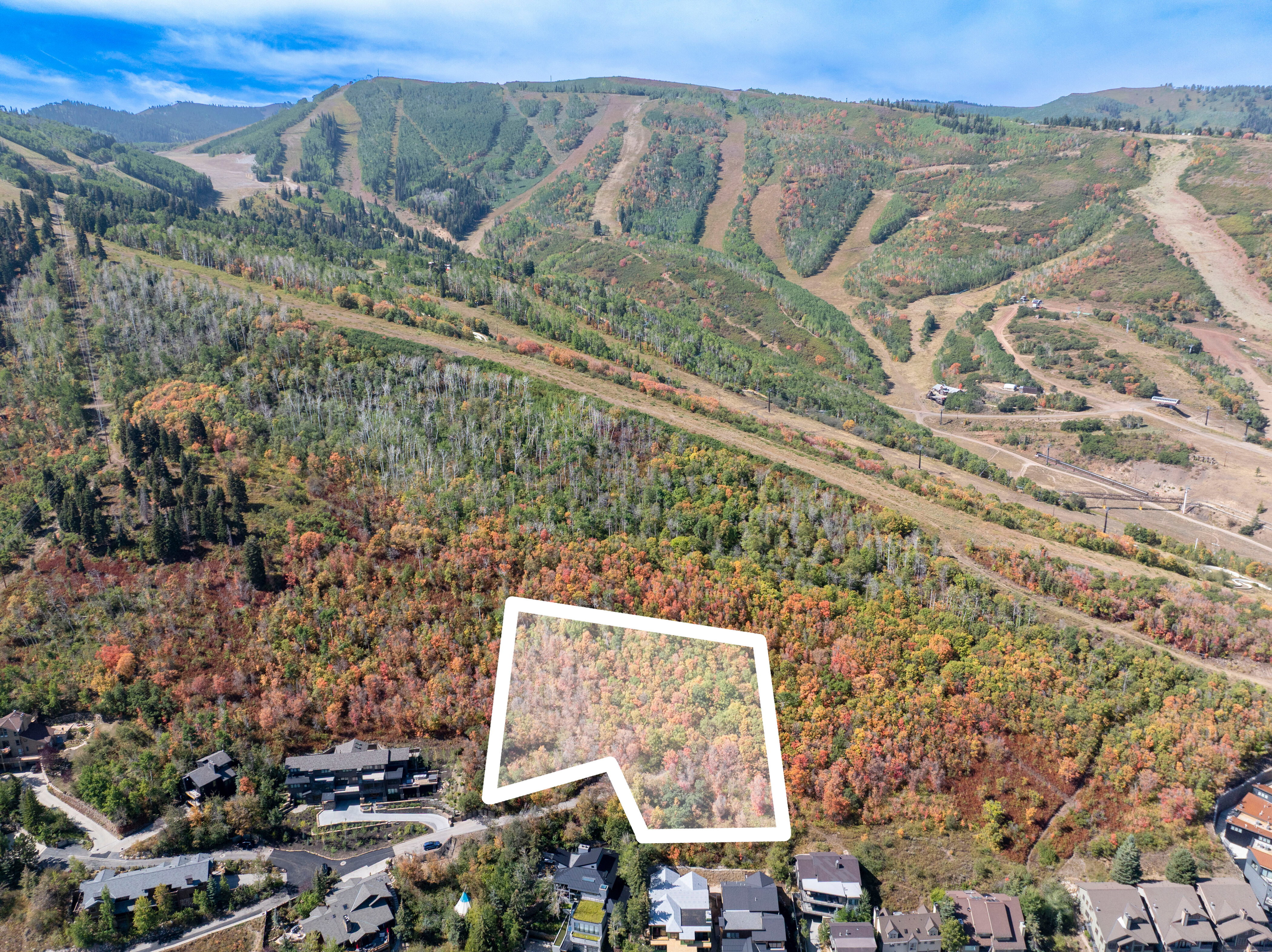 Aerial overview of property's location with property boundaries highlighted and a mountain backdrop