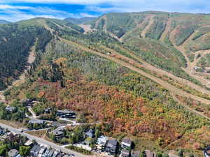 Aerial view of property's location featuring nearby suburban area and a mountain backdrop