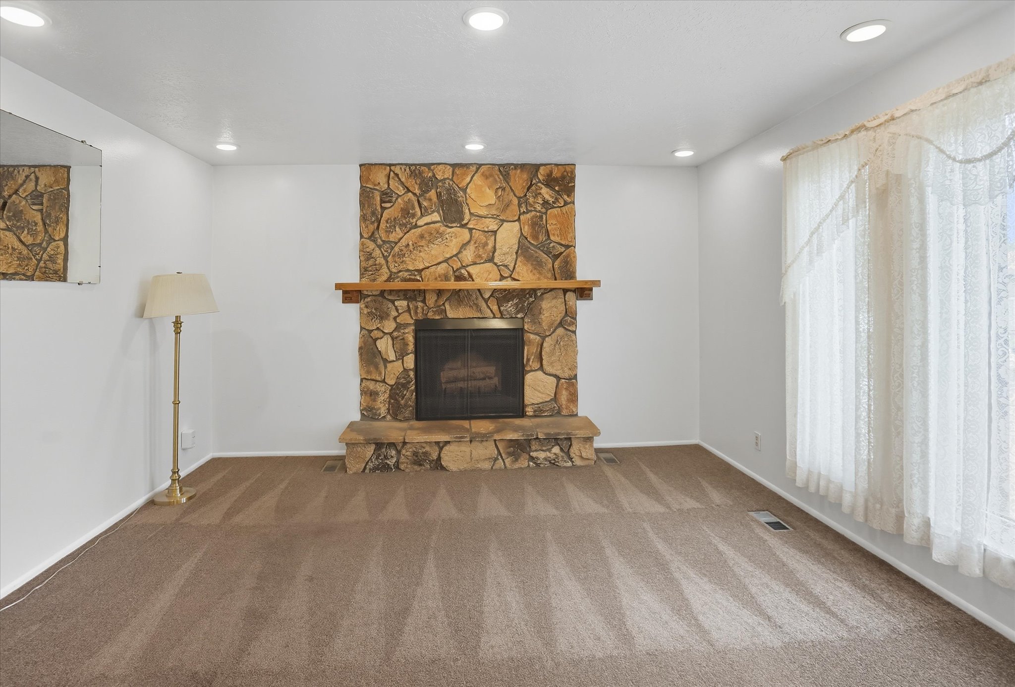 Living room with a fireplace, carpet