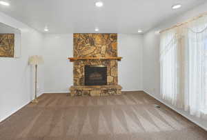 Living room with a fireplace, carpet