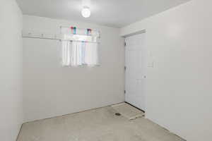 Spare room with unfinished concrete floors