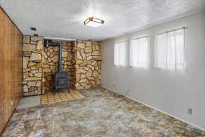 Living room with a wood stove, carpet floors