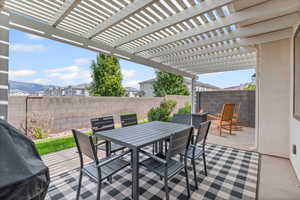 Backyard with outdoor dining space, a patio, grilling area, and a pergola