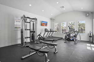 Workout area featuring vaulted ceiling and recessed lighting