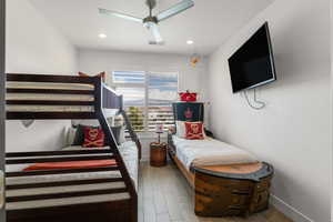 Bedroom with light wood-style flooring, ceiling fan, and recessed lighting