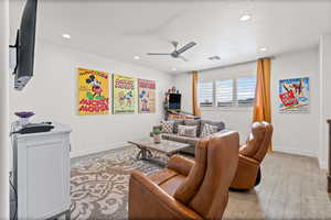 Living area featuring ceiling fan, recessed lighting, and tile floors