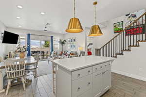 Kitchen with open floor plan, tile floors, pendant lighting, a kitchen island, and recessed lighting