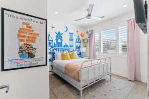 Bedroom with wood finished floors, ceiling fan, and recessed lighting